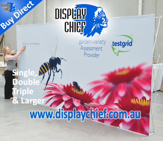 Lady inspecting the freestanding pop up display wall sign which is two frames and a single print graphic sign